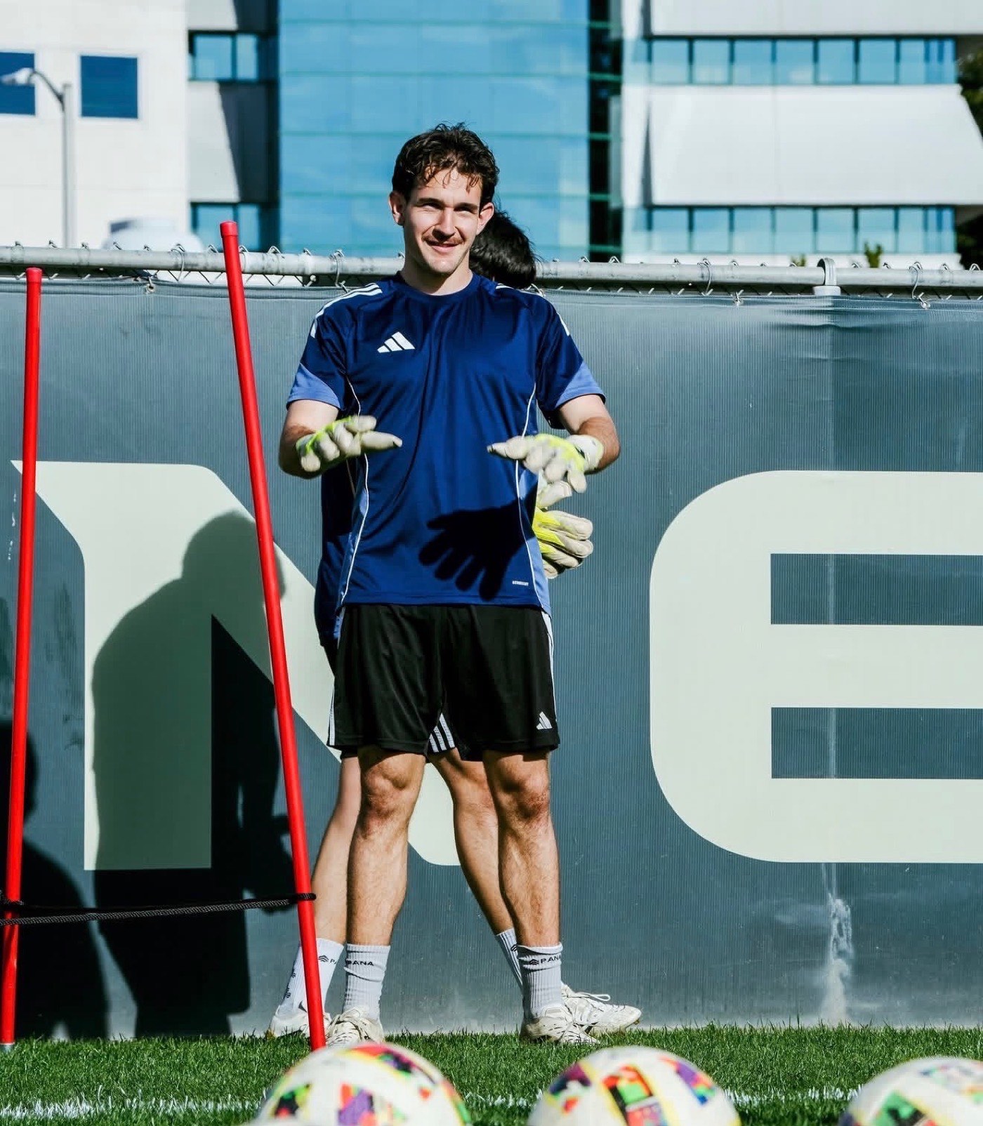 Soccer goalkeeper in blue jersey warming up before a match